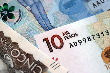 Colombian pesos money bills banknotes lies in big pile on table close up. Concept of finances and business in Colombiaの写真素材