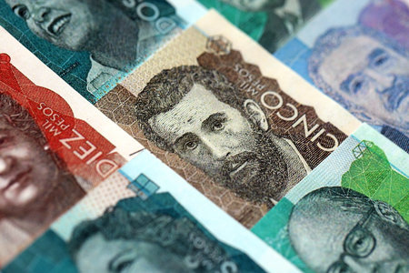 Colombian pesos money bills banknotes lies in big pile on table close up. Concept of finances and business in Colombiaの写真素材