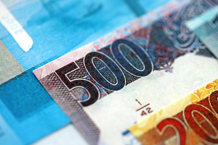 Qatari riyal money bills banknotes lies in big pile on table close up. Concept of finances and...