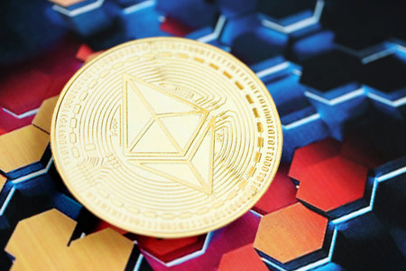 KYIV, UKRAINE - OCTOBER 9, 2025 Ethereum cryptocurrency coin sticker on hexagonal abstract banner. Concept of modern crypto moneyのeditorial素材