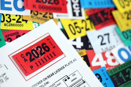 KYIV, UKRAINE - OCTOBER 1, 2025 Red tag 2026 on United States car registration tag stickers in big pile close upのeditorial素材