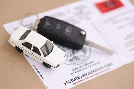KYIV, UKRAINE - OCTOBER 1, 2025 Validated registration card with remote control car keys close upのeditorial素材