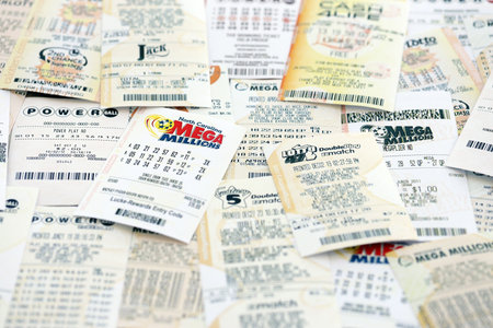 KYIV, UKRAINE - OCTOBER 22, 2025 Big pile of lottery tickets from different US lotteries with various titlesのeditorial素材