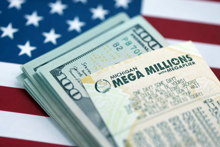 KYIV, UKRAINE - OCTOBER 22, 2025 Mega Millions lottery ticket lies on dollar bills and US flag close upのeditorial素材