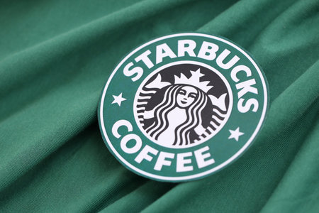 KYIV, UKRAINE - OCTOBER 5, 2025 Starbucks coffee brand logo on green fabric cloth background close upのeditorial素材