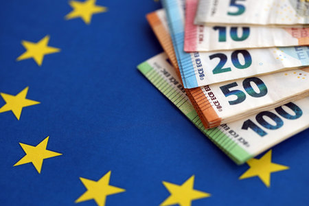 European eur currency money bills on Euro union blue flag close up. Concept of business and...