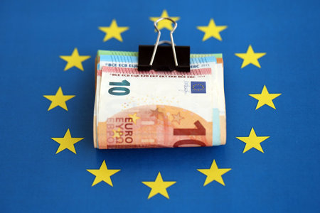 European euro currency money notes bunch on Europe union blue flag close up. Concept of business and economics in Europeの写真素材