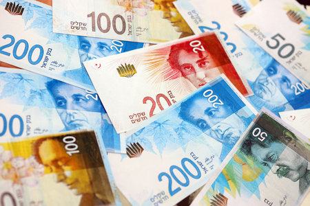 Israel New Shekels banknotes. The current Israel money bills lies on table in big amount. The concept of business and investment in Israelの写真素材