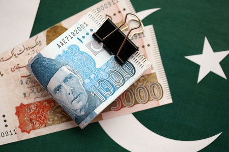 Pakistan rupees banknotes on Pakistani flag. The current Pakistan money bills lies on banner in big amount. The concept of economics and business in Pakistanの写真素材