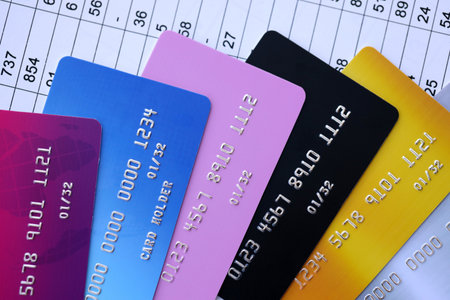 Many credit or debit cards with fictional specimen numbers on business calculations document. Big amount of banking plastic cards of various colors. Financial concept of business and e-commerceの写真素材