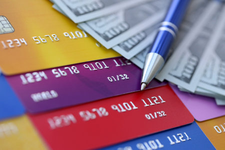 Credit cards and pen with US dollar currency money bills banknotes. Business, financial operations and accounting in United States of Americaの写真素材