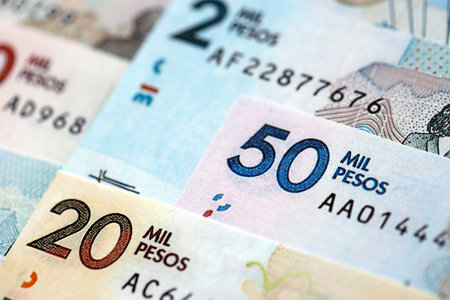 Colombian pesos money bills banknotes lies in big pile on table close up. Concept of finances and business in Colombiaの写真素材