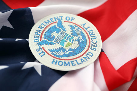 KYIV, UKRAINE - OCTOBER 7, 2025 US Department Of Homeland Security emblem on United States flag close upのeditorial素材