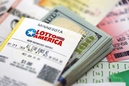 KYIV, UKRAINE - OCTOBER 22, 2025 Lotto America lottery ticket with money on many other tickets close upのeditorial素材