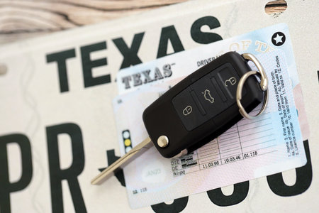 Remote control car keys on Texas license plate with driver license. Concept of driving in Texas. Reaching a driving permitの写真素材