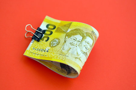 Philippines peso money bills in big amount close up on red. Finance and banking concept