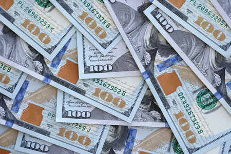 Many one hundred dollars money bills banknotes on smooth surface close up. Concept of business, rich life and economical questions in United States of America and around the worldの写真素材