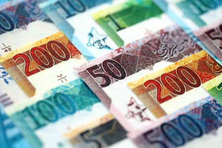Qatari riyal money bills banknotes lies in big pile on table close up. Concept of finances and...