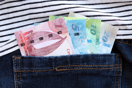 Bahraini dinar money bills in denims pocket close up. The concept of fashion and wealth
