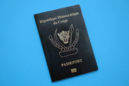 Democratic Republic of Congo black passport on light blue table background close up. Concept of travel and tourismの写真素材