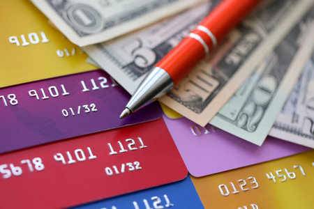 Credit cards and pen with US dollar currency money bills banknotes. Business, financial operations and accounting in United States of Americaの写真素材