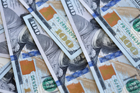 Many one hundred dollars money bills banknotes on smooth surface close up. Concept of business, rich life and economical questions in United States of America and around the worldの写真素材