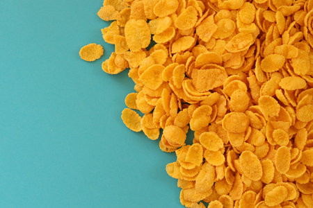 Background of breakfast cereals in big amount on blue background close up, top viewの写真素材