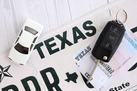 Remote control car keys on Texas license plate with driver license. Concept of driving in Texas. Reaching a driving permitの写真素材