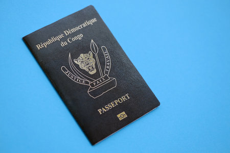 Democratic Republic of Congo black passport on light blue table background close up. Concept of travel and tourismの写真素材