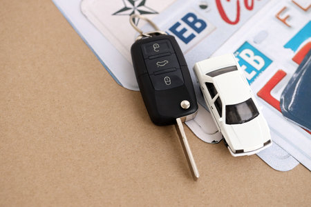 Remote control car keys on US license plates with state names close up. Concept of driving in United...