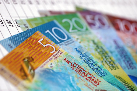 New Zealand dollars money bills banknotes on document with business calculations table close up....