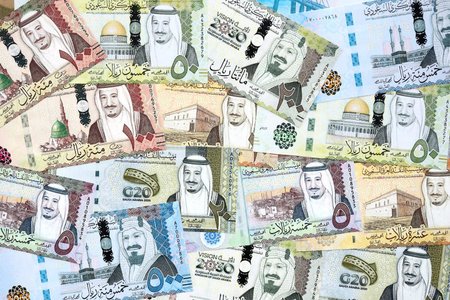 Saudi Arabia riyal money bills banknotes lies in big pile on table close up. Concept of finances and business in Saudi Arabiaの写真素材