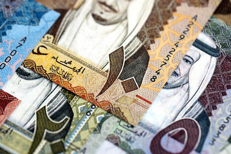 Saudi Arabia riyal money bills banknotes lies in big pile on table close up. Concept of finances and...