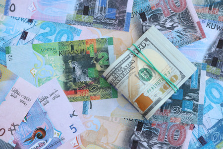 Kuwaiti dinar currency money bills and bunch of us dollar banknotes close up. The concept of...