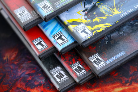 KYIV, UKRAINE - SEPTEMBER 8, 2025 ESRB game rating on a stack of PlayStation5 videogames close up. Entertainment Software Rating Boardのeditorial素材