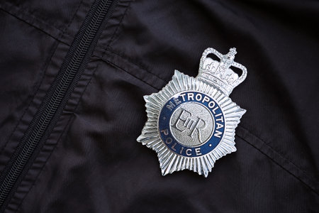 KYIV, UKRAINE - SEPTEMBER 17, 2025 UK Metropolitan Police badge on black uniform fabric surface close upのeditorial素材