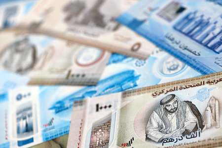United Arab Emirates dirham currency money bills. The current banknotes lies on table in big amount...