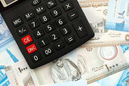 United Arab Emirates dirham currency money bills and calculator close up. The concept of taxation...