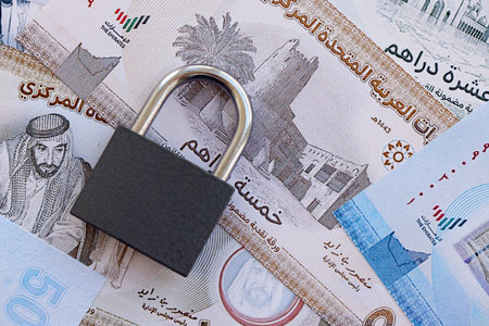 United Arab Emirates dirham currency money bills and padlock close up. The concept of sanctions and...