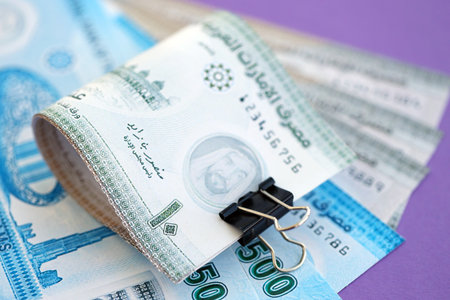 United Arab Emirates dirham money bills in big amount close up on purple. Finance and banking...