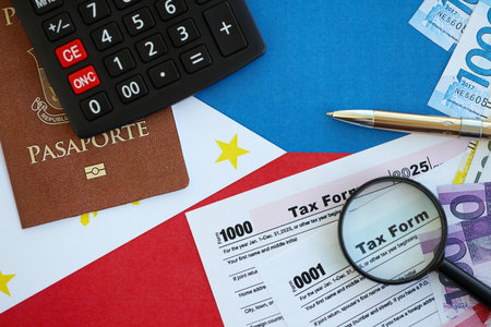 Philippines peso money bills and calculator with tax form on flag close up. Taxation and accounting...