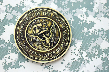KYIV, UKRAINE - OCTOBER 7, 2025 Department of the Navy logo on pixel camouflage fabric close up