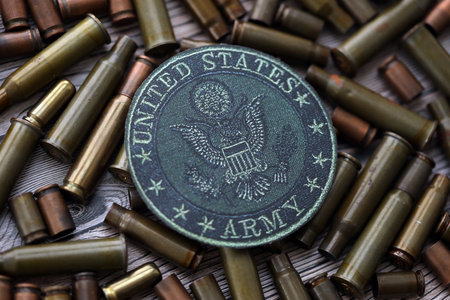KYIV, UKRAINE - OCTOBER 7, 2025 United States Army patch on many bullet shells close up