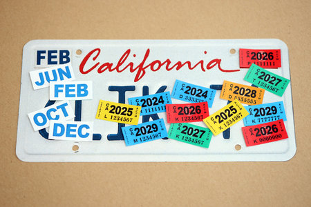 KYIV, UKRAINE - OCTOBER 1, 2025 Many California car registration tag stickers on license plate close...