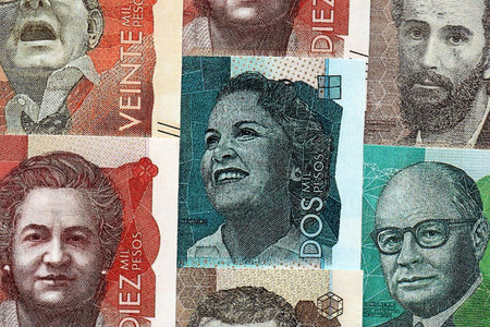 Colombian pesos money bills banknotes lies in big pile on table close up. Concept of finances and...
