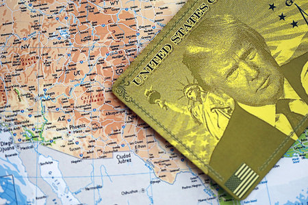 KYIV, UKRAINE - DECEMBER 13, 2025 Trump gold card souvenir on United States map background. Visa...