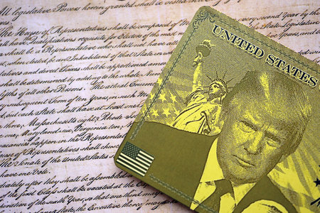 KYIV, UKRAINE - DECEMBER 13, 2025 Trump gold card souvenir on United States Constitution replica...