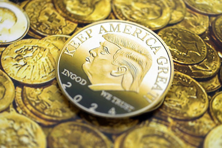 KYIV, UKRAINE - DECEMBER 13, 2025 Trump gold coin on shiny golden coins background print close upのeditorial素材