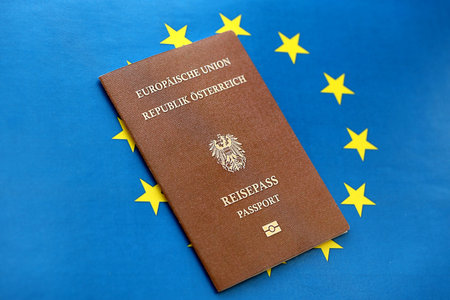 Austria passport on European union blue flag background close up. Citizenship in countries of Europe conceptの写真素材