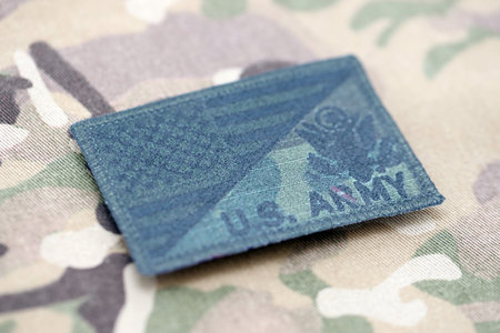 KYIV, UKRAINE - OCTOBER 7, 2025 United States Army patch on multicam camouflage fabric close up